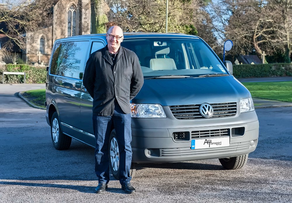The Able Transport driver in Surrey standing beside the grey Able Transport man and van